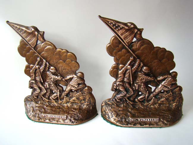 An extremely fine and RARE pair of World War II vintage solid bronze bookends depicting "Raising of the Flag" on Mt. Suribachi,Iwo Jima, by five U.S. Marines and a U S Navy corpsman, February 23, 1945.
